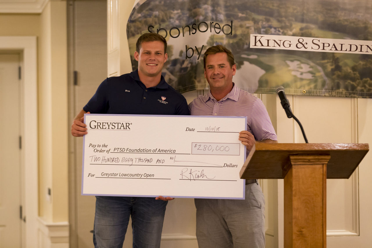 Wes Fuller, Executive Managing Director of Global Investment Management presents check to PTSD Foundation representative. October 10, 2018.